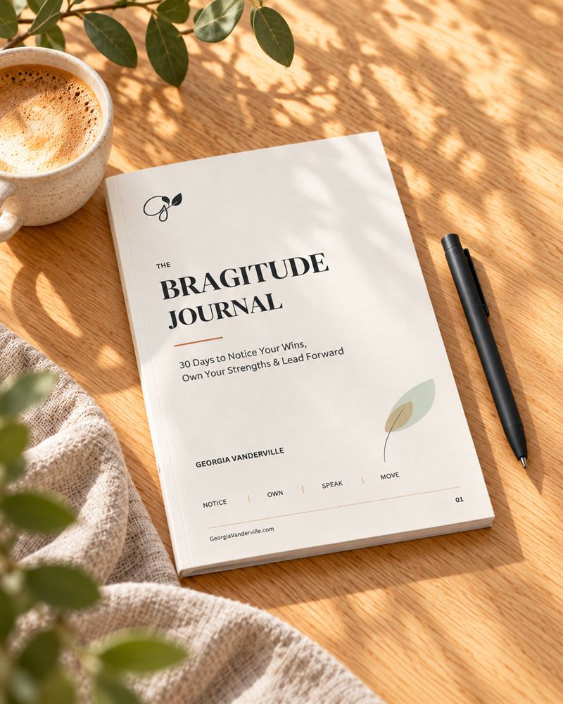 The Bragitude Journal on a sunlit desk beside a cup of coffee and a pen